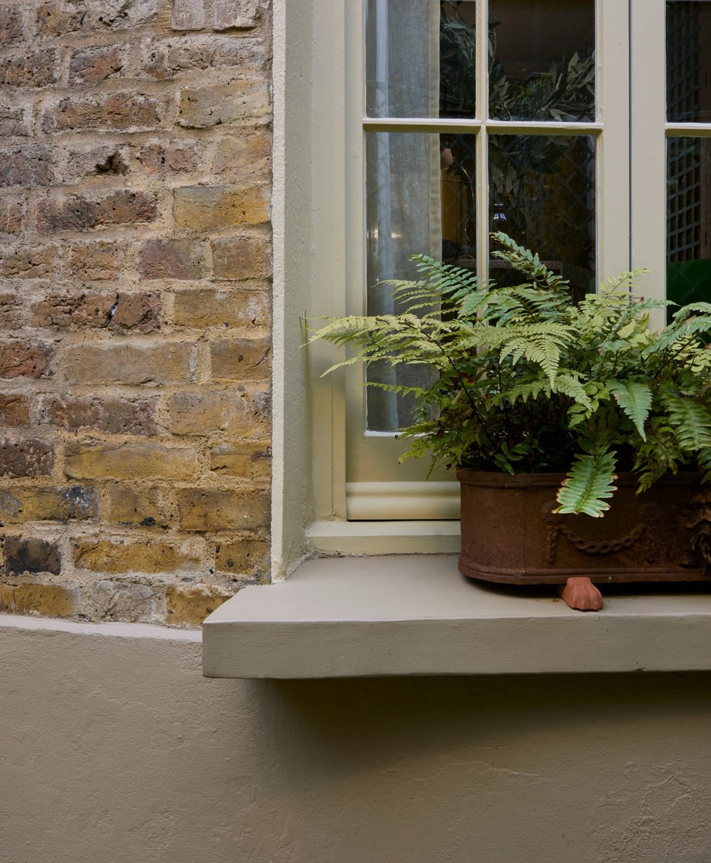 brick building with masonry painted in earthy neutral paint