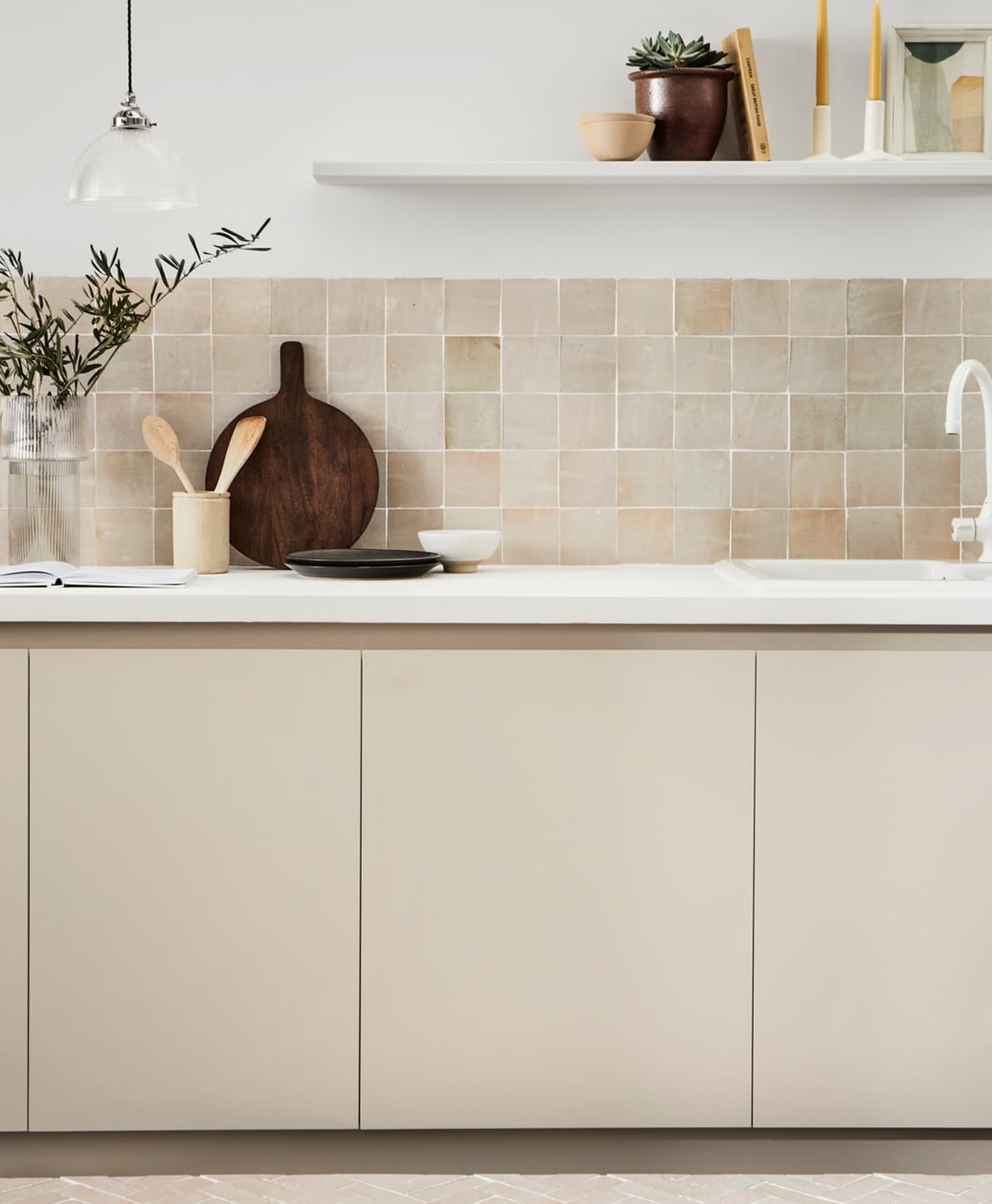 Neutral modern kitchen with beige tiles, white countertops, and wooden accents.
