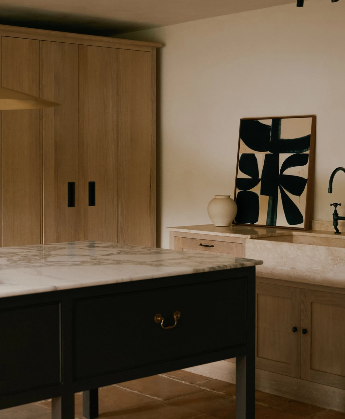 Modern kitchen with mocha brown island, plaster painted walls and wooden cabinets