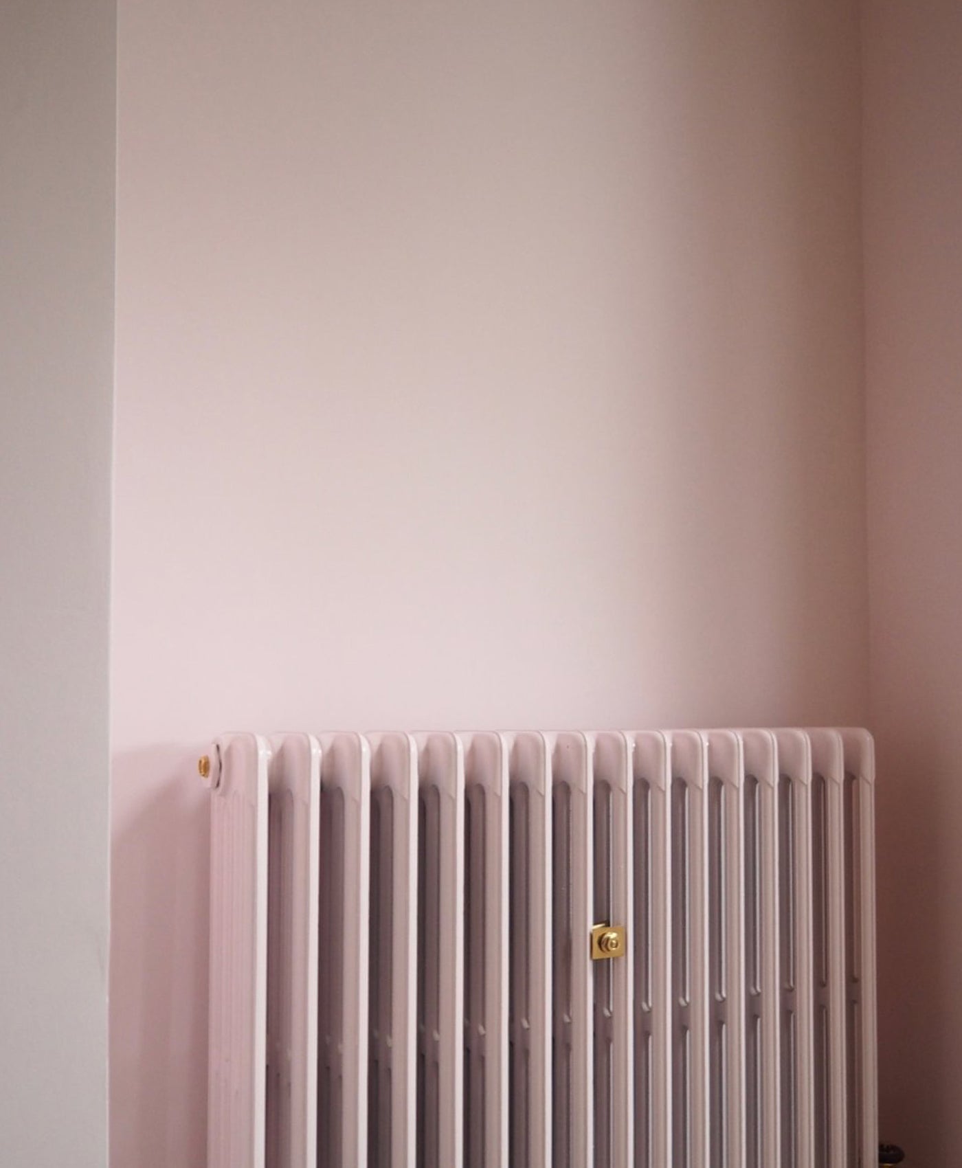 pastel Pink radiator against a light pink wall