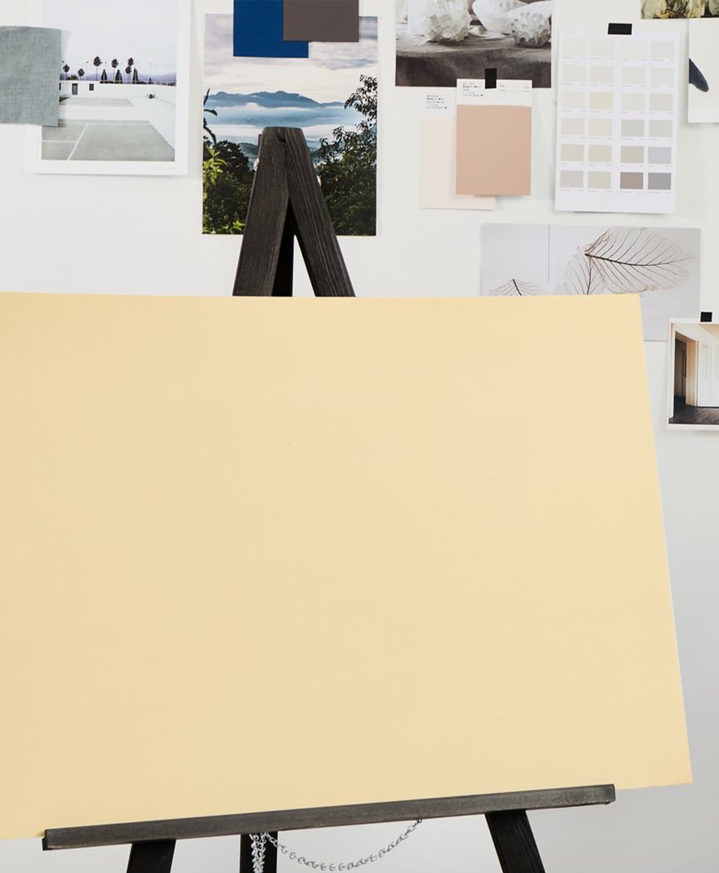 Beige canvas on an easel with color swatches in the background