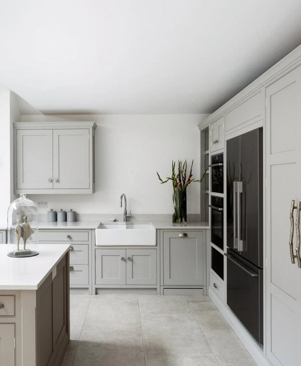 Classic grey kitchen with white walls, black appliances, and a central island.