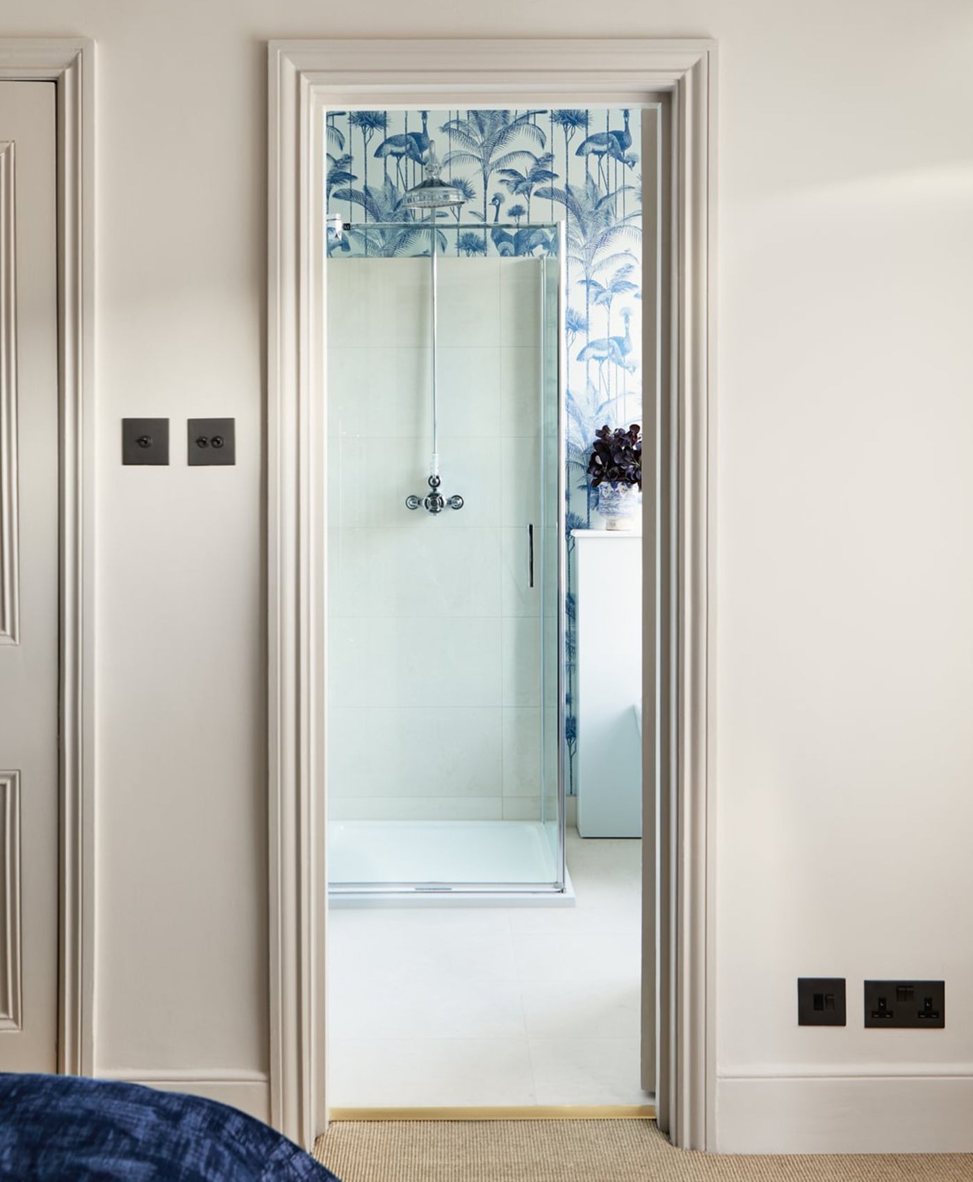 Decorative glass door with floral pattern in a neutral-colored room.