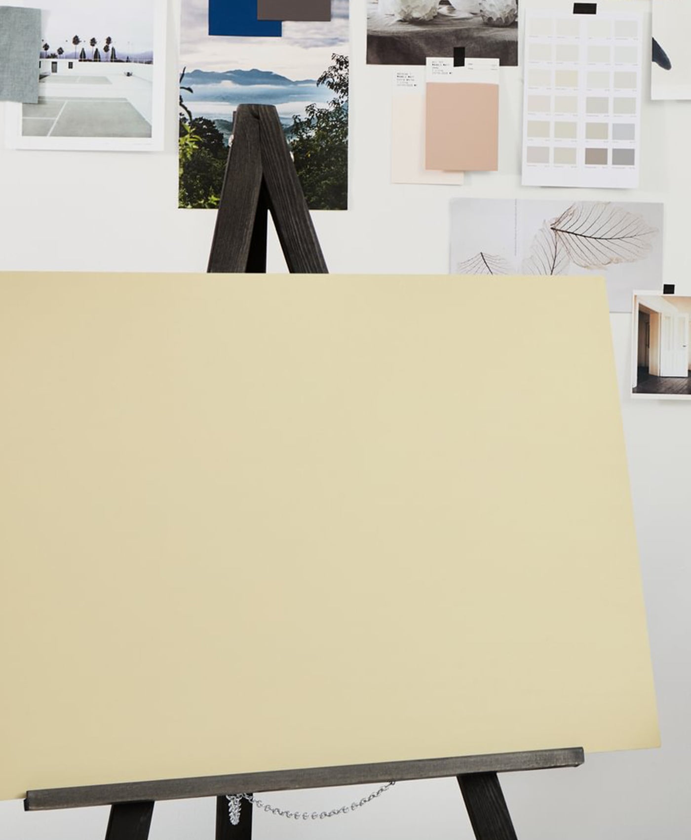 light olive color swatch on a stand with a white wall and color samples in the background
