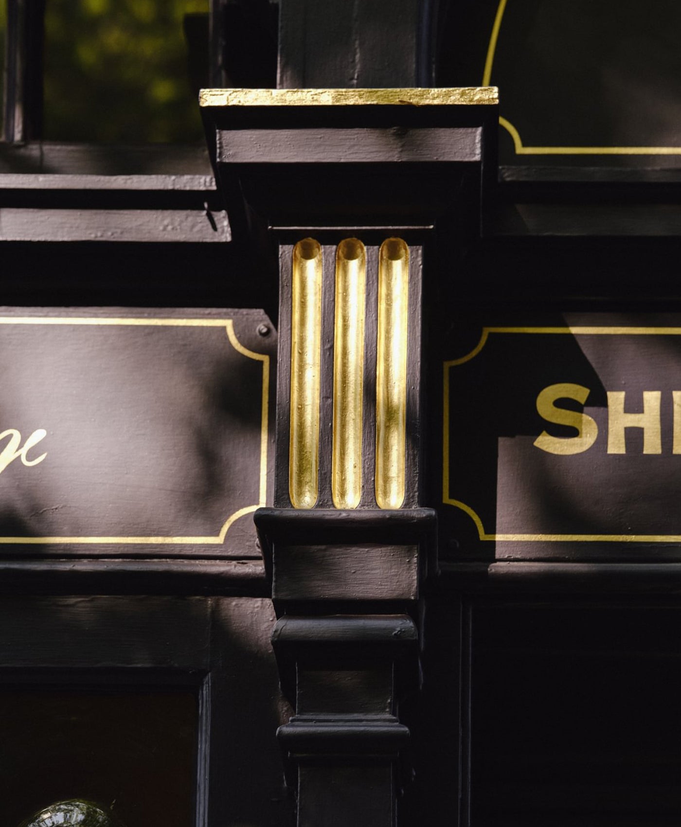 Pub exterior with gold accents on a black background