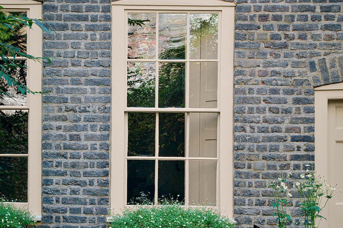 Wooden window frame painted in Cooper's Earth JB05 coloured paint