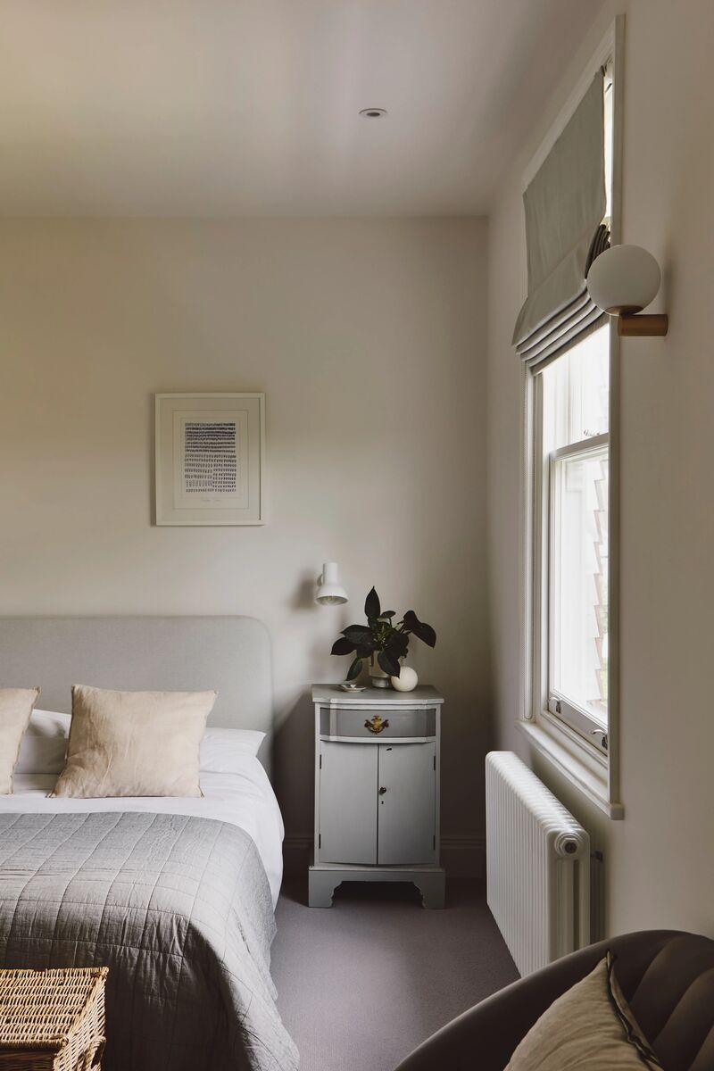 Neutral bedroom with walls painted in Mylands Cotton Street. 